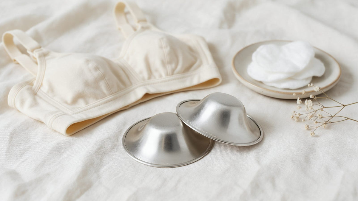 Pair of Turtees pure 999 silver nursing cups on soft linen with a nursing bra